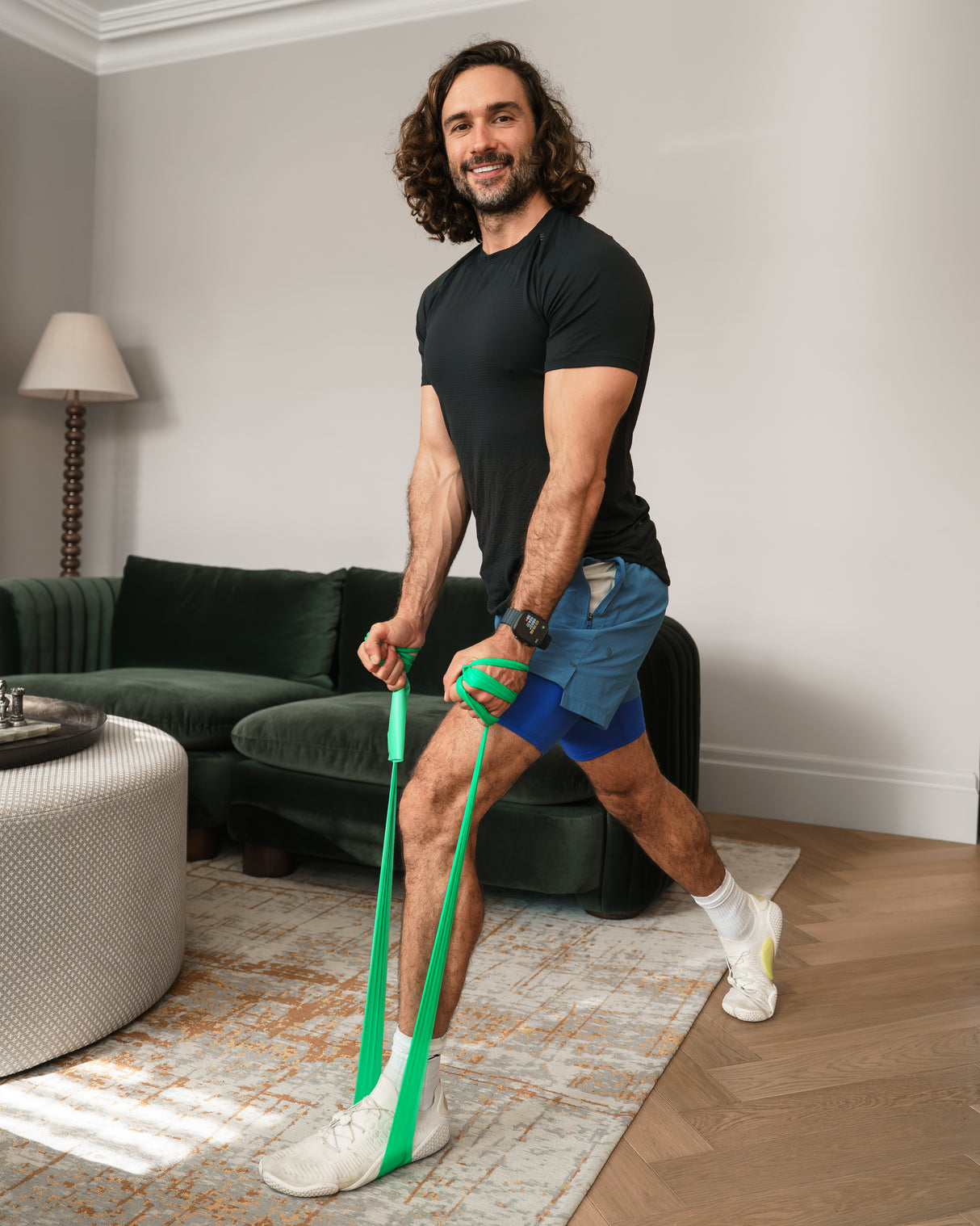 Man exercising with a resistance band in a living room