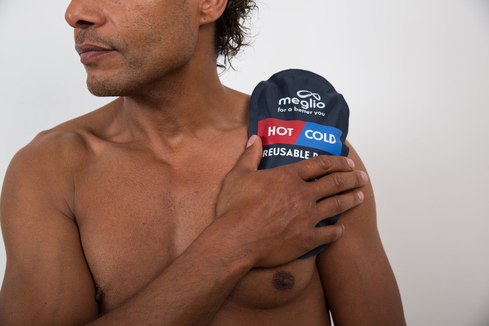 Man using hot & cold pack on shoulder