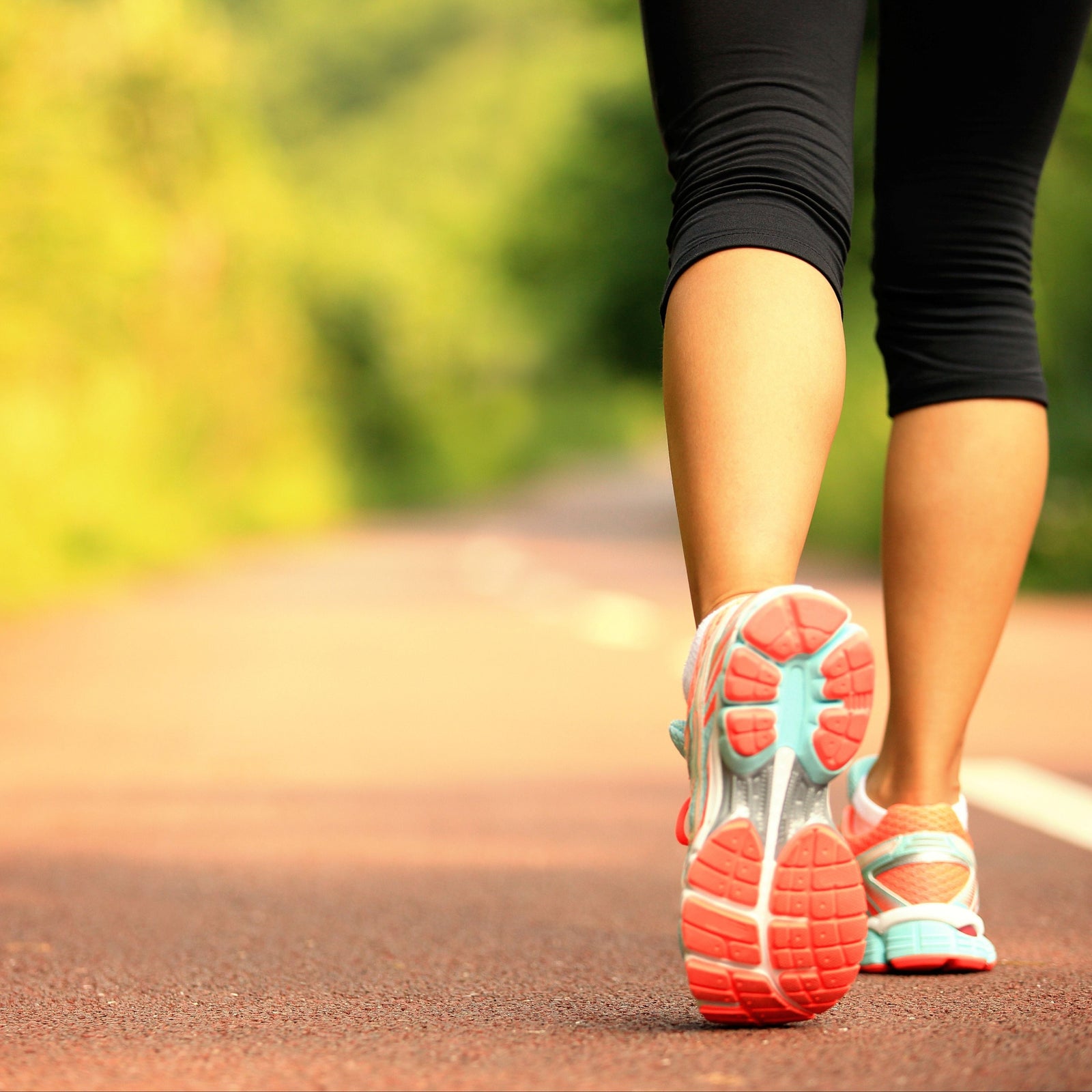 Woman walking in trainers close up