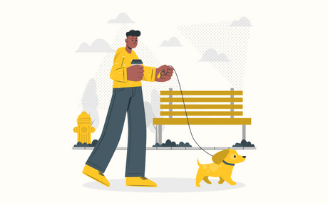 A person walking a lively dog through a park.